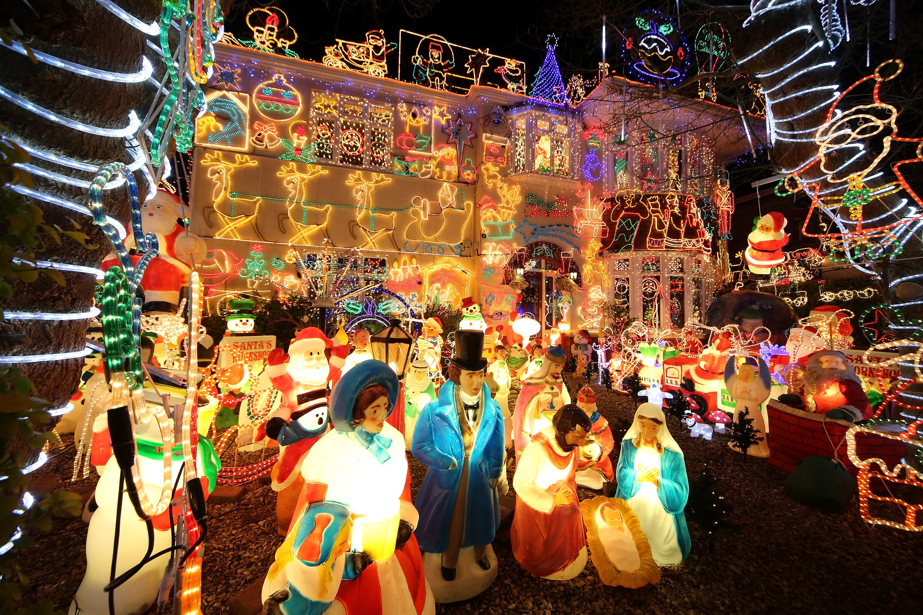 MELKSHAM, ENGLAND - DECEMBER 08: Christmas festive lights adorn a detached house in a suburban street in Melksham, December 8, 2012 in Melksham, England. The lights, a popular festive attraction, have returned to the town after a two-year absence and have raised thousands of pounds for charity for a local hospice, Dorothy House. The display, which is estimated to involve over 100,000 bulbs, worth over 30,000 GBP and even needed an up-rated electricity supply installed to cope with the additional power needed, is the brainchild of householder and electrician Alex Goodhind. This year, the display which Mr Goodhind began fifteen years ago now takes a team of professional electricians five weeks to complete, and even includes a snow machine. (Photo by Matt Cardy/Getty Images)