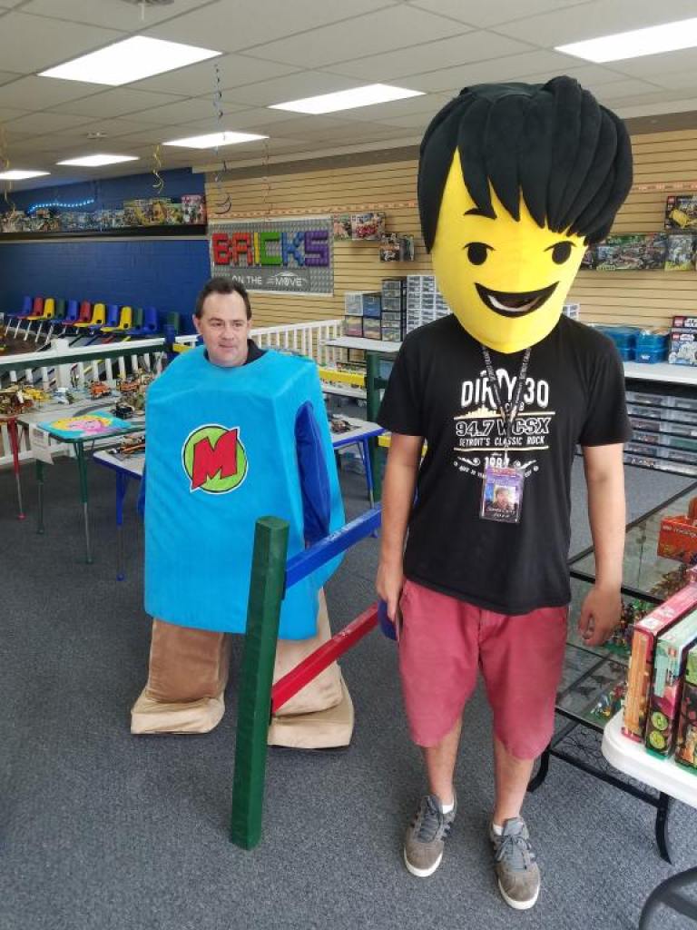 two men wearing opposite parts of a Lego costume. This pic is used (among others) for a stroy about the average amount spent on holiday gifts for kids.