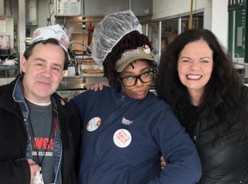 The Troy Krispy Kreme donut shop: a man and two women are smiling