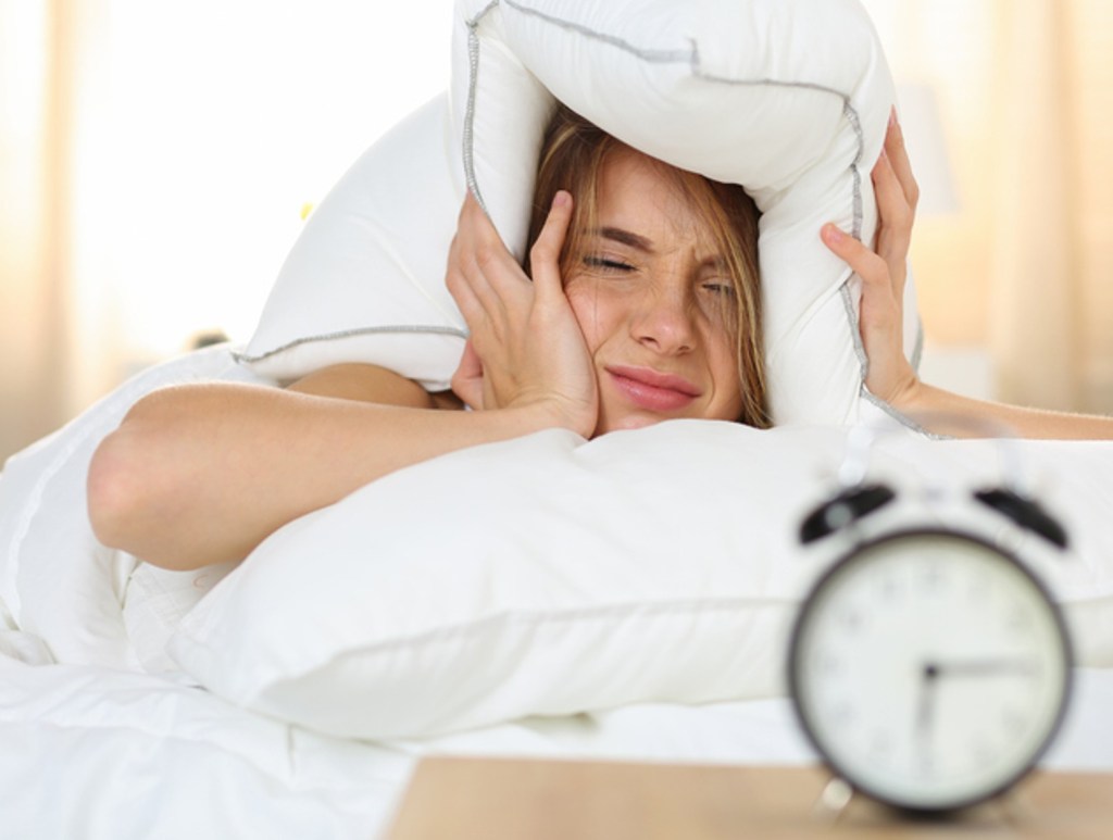 woman lying in bed (Cracking the Code of Waking Up Tired: Reasons and Remedies)