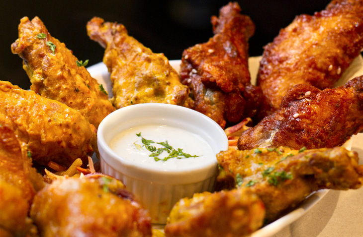 A variety of flavors of jumbo chicken Wings and ranch