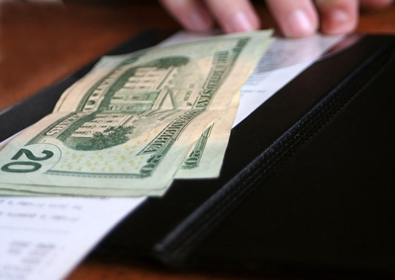 Image of a bill being paid at a restaurant.