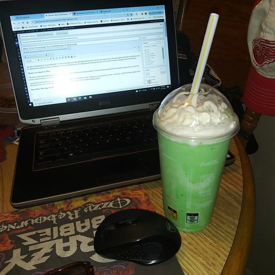 A Green mint shake next to a computer from McDonalds