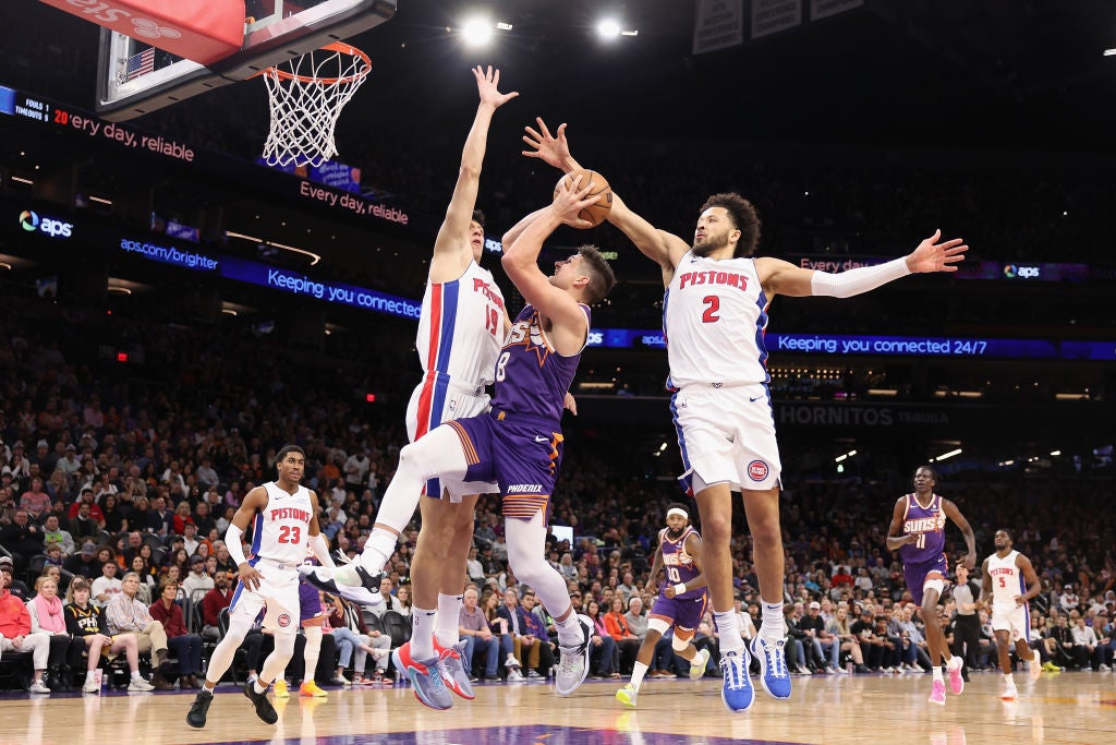 Grayson Allen #8 of the Phoenix Suns attempts a shot against Simone Fontecchio #19 and Cade Cunningham #2 of the Detroit Pistons during the first half of the NBA game at Footprint Center. A major Detroit Pistons shakeup is happening. So, who will be the new game-changing general manager?