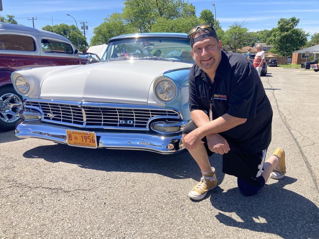 Man poses with 1956 chevy bel air in eastpointe.