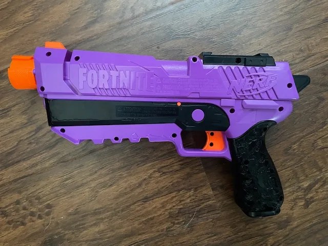 a purple Fortnite Nerf gun. Part of an article discussing stunning colors that are actually song titles