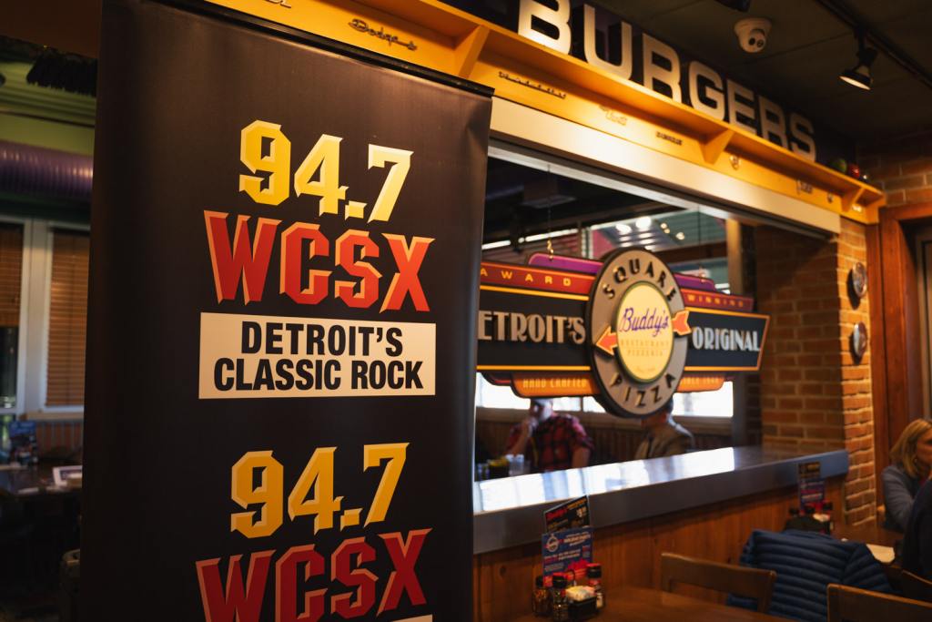 WCSX banner with 'Detroit's Classic Rock' text displayed at Buddy's Pizza during Big Jim’s House 'I Thank You' Luncheon on November 7, 2024.